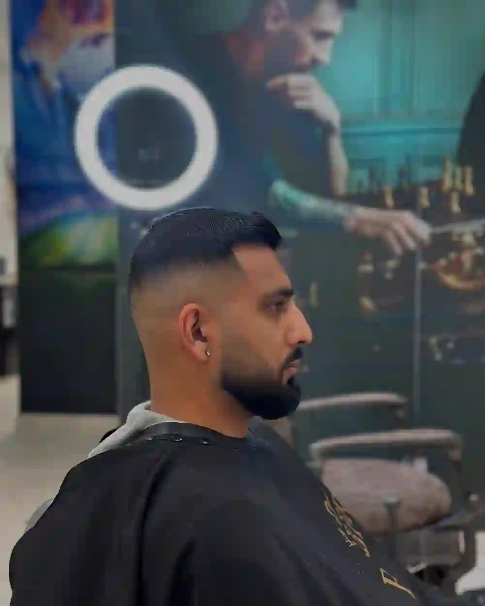 Sharp taper fade with beard lineup at The Fade District