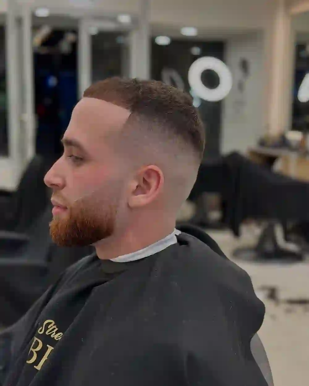 Crisp skin fade with beard sculpt